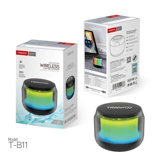 TRANVOCO T-B11 wireless portable speaker shown with its retail packaging boxes on a white background, alongside the speaker itself. The speaker has a black top and bottom with a vibrant green-to-blue gradient illuminated center.